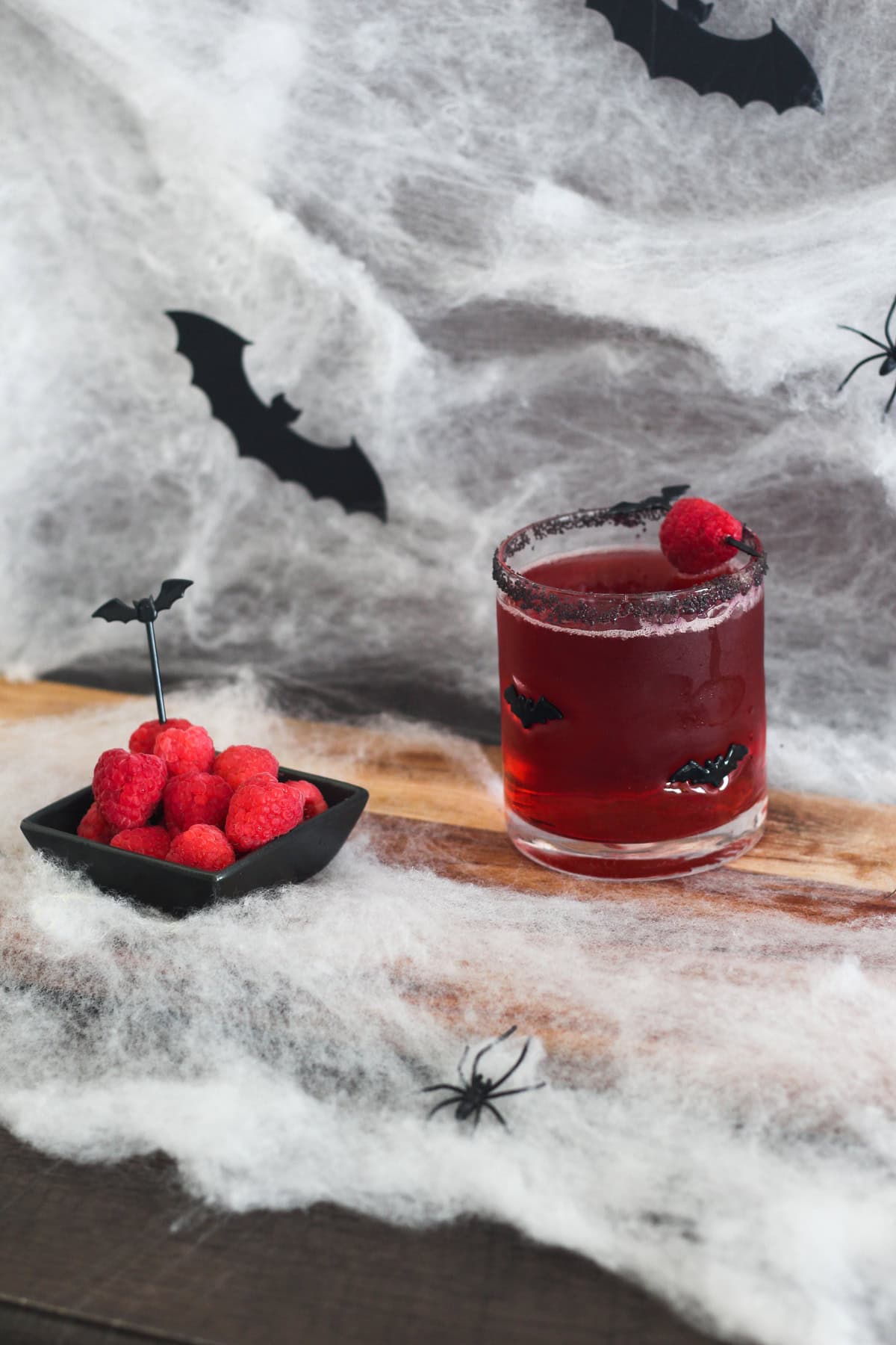 Vampire's Kiss Cocktail with raspberries on the side.