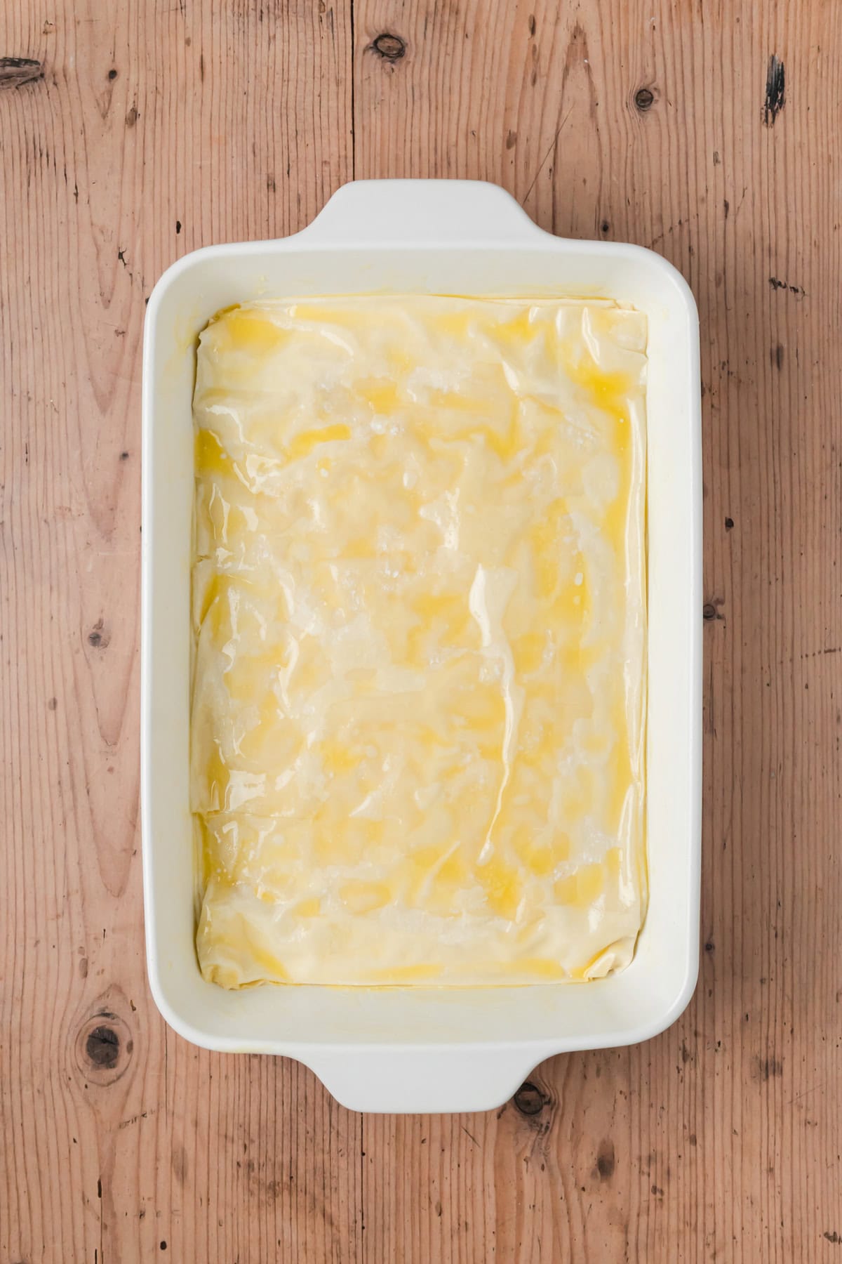 Phyllo dough sheets with butter sprinkled over the top.