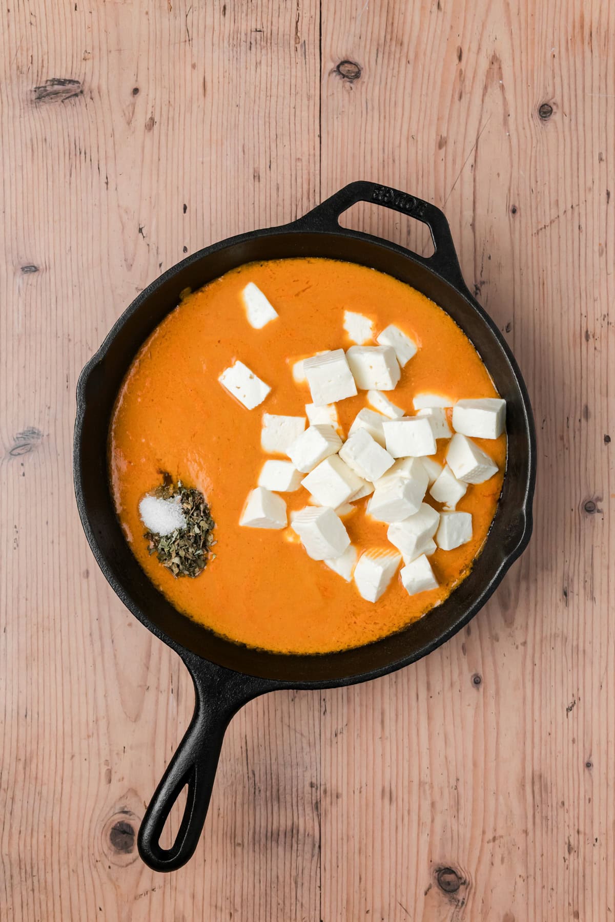 Sugar, fenugreek leaves, and paneer added to the skillet. 
