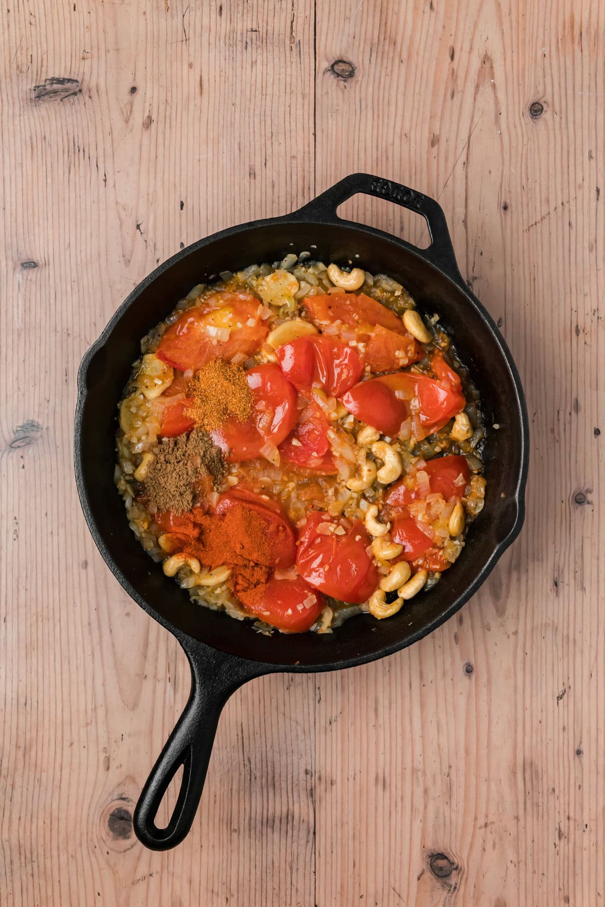 Paprika, coriander, and garam masala added to the skillet. 